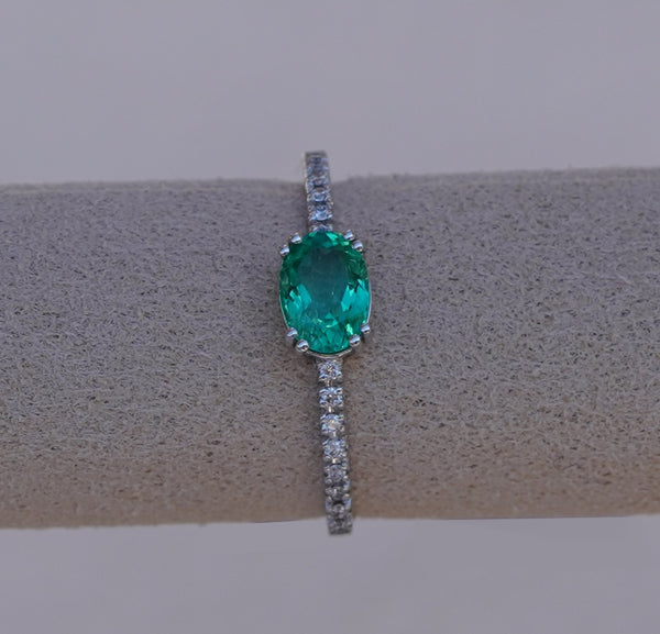 Subtle Oval Emerald Solitaire Ring with Diamond Pavé